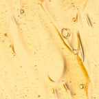 Close-up of a Age-defy
elixir with bubbles on a textured surface