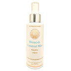 Blemish control mist bottle with pineapple and papaya ingredients on a white background