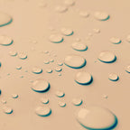 Close-up of water droplets for the Blemish Control Mist on a textured surface