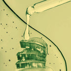 Close-up of a dropper with Blemish Spot Remover on a textured surface.