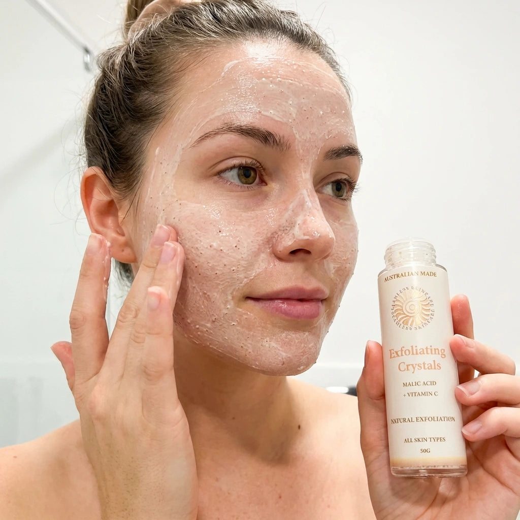 Woman applying Exfoliating Crystals to her face with a bottle of Exfoliating Crystals in hand.