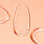 Close-up of Gleaming Eye Gel on a peach-colored background