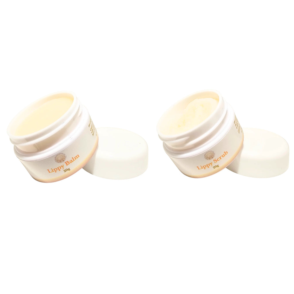Two white jars of lippy balm and scrub on a white background