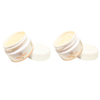 Two white jars of lippy balm and scrub on a white background