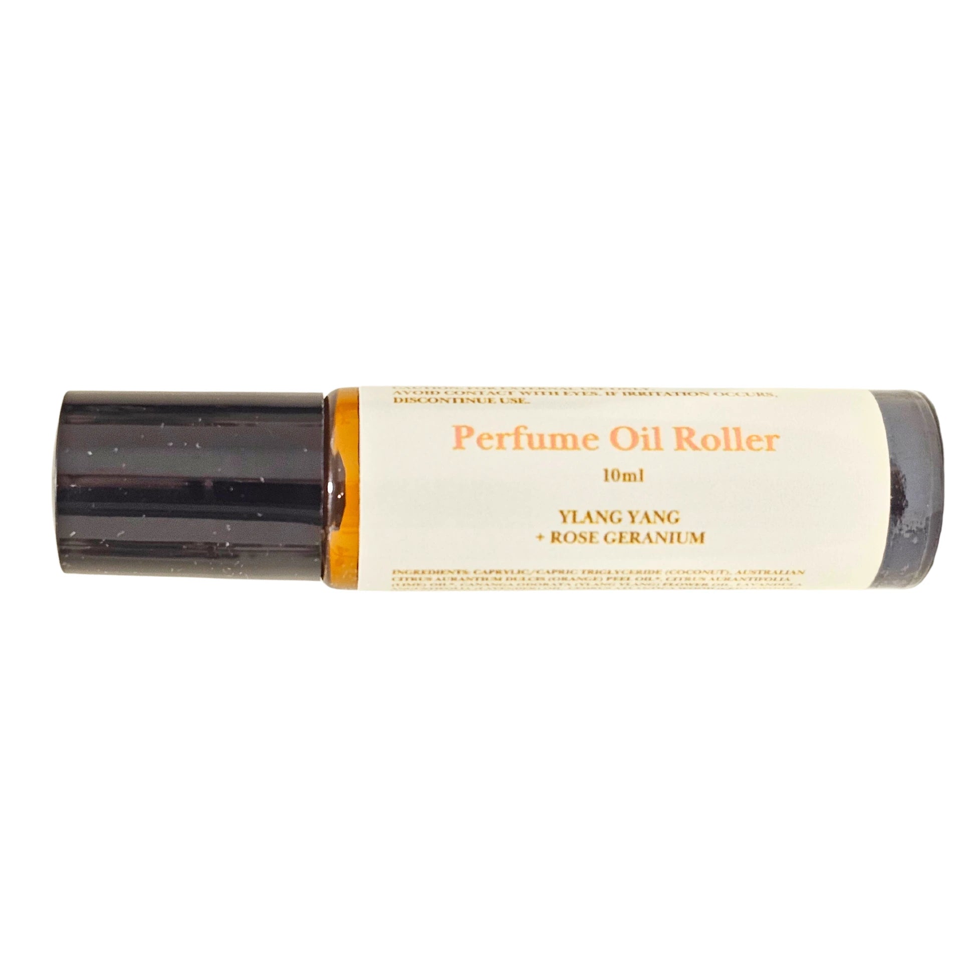 Perfume oil roller with black cap and cream label on a white background