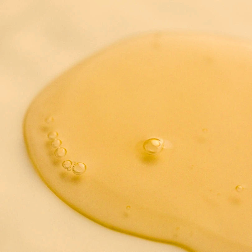 Close-up of the Revitlising A Oil oil with bubbles on a beige background